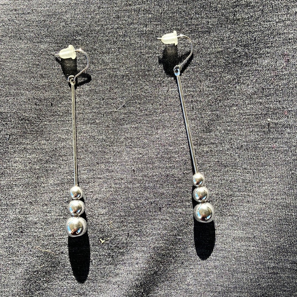Silver colored long drop ball earrings